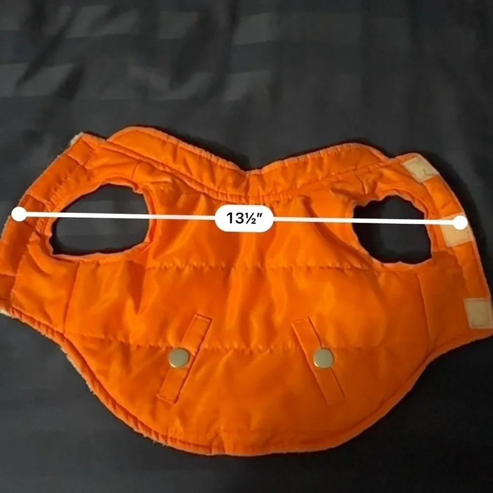 Small orange dog vest pockets are for decoration only.